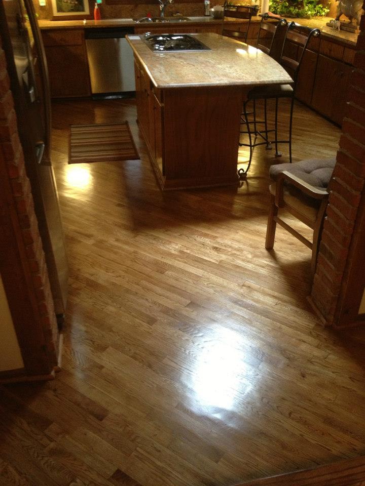 a refinished and maintained hardwood floor in a kitchen