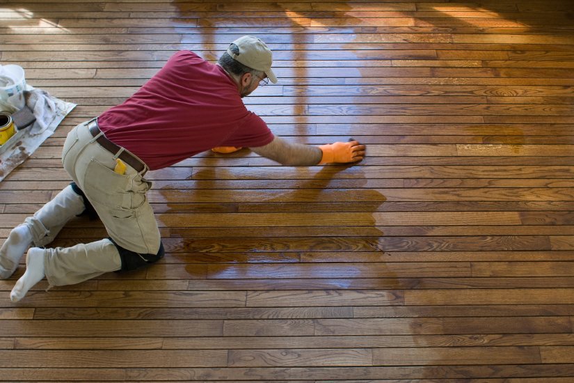 a fabulous floors technician staining wood floor